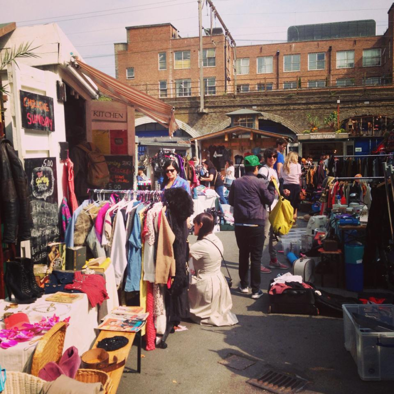 Attendees walking around hackney market on a sunny day