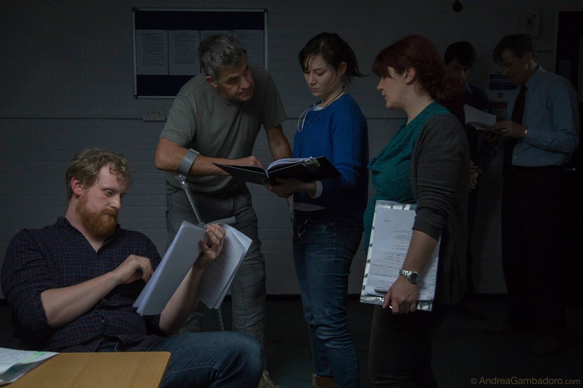 Max Brill, cinematographer based at Hackney Downs Studios, working with the cast on a film production set.