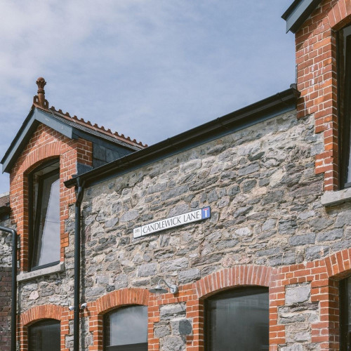 Exterior view of Alma Yard on Candlewick Lane, showcasing historic stone and brick architecture in Plymouth’s creative district.