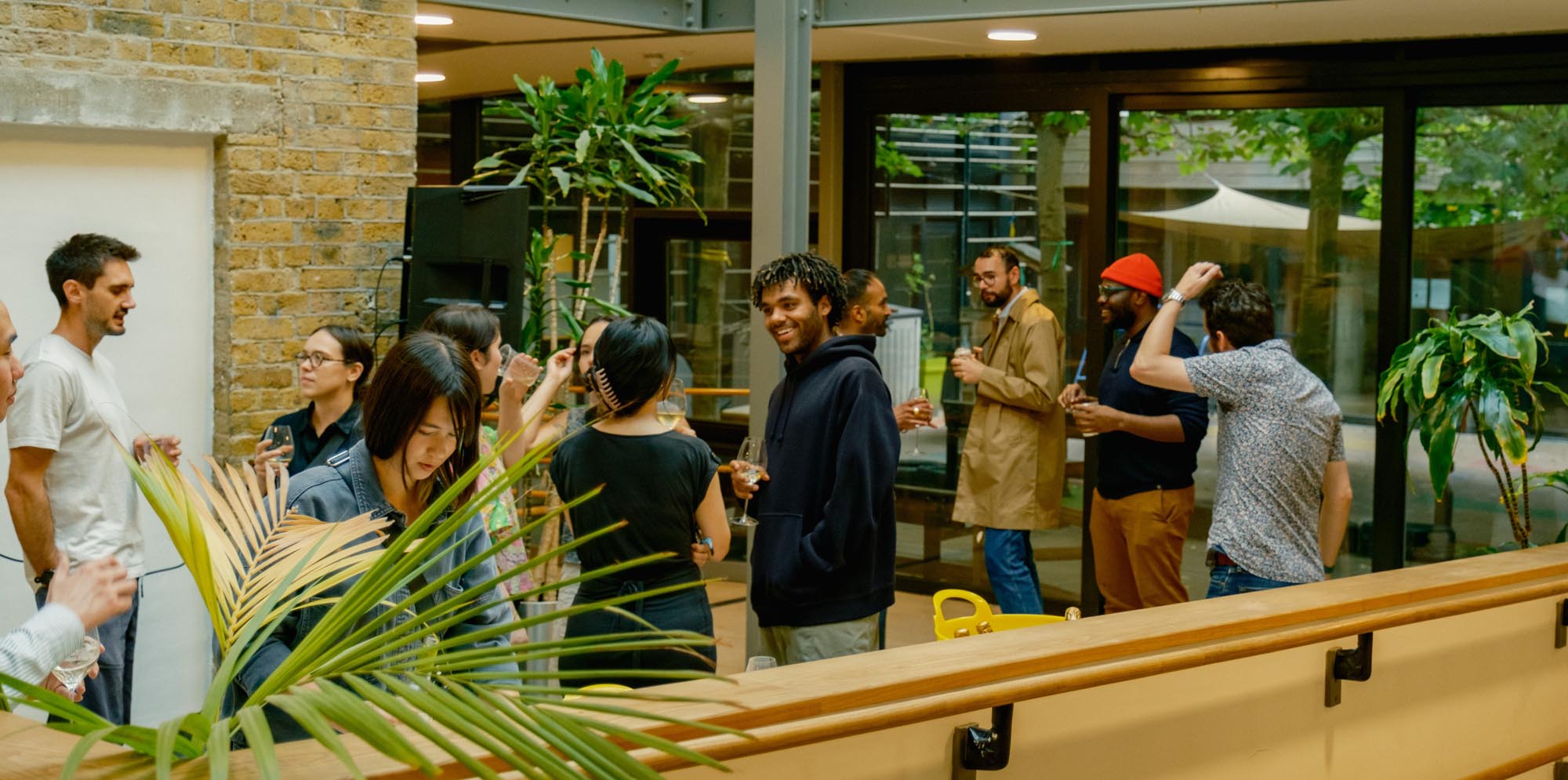 Residents socialising at Cornerstone Studios, with indoor-outdoor flow and relaxed creative atmosphere