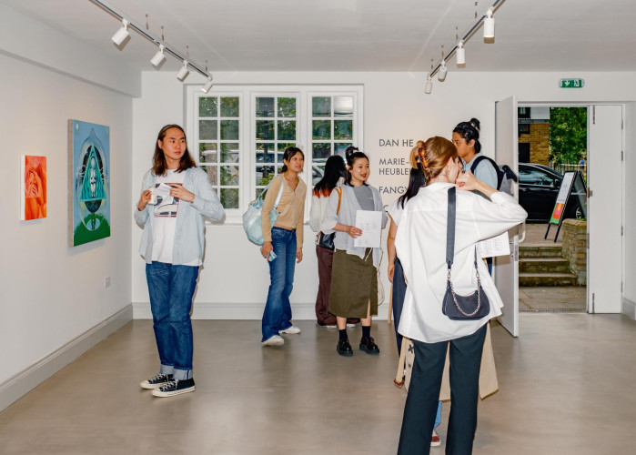 Visitors engaging with contemporary art during an exhibition opening at Cornerstone Studios’ on-site gallery