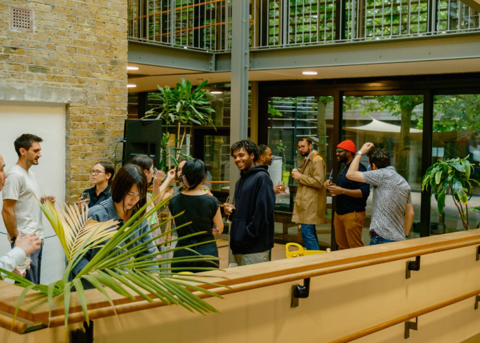 Creative professionals gathering for a resident event inside the leafy atrium of Cornerstone Studios, Camberwell