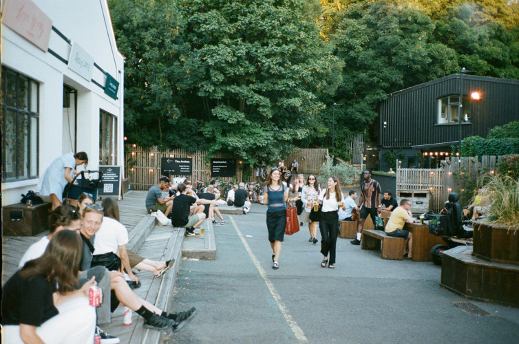 Creative residents and visitors enjoying the outdoor space at Hackney Downs Studios
