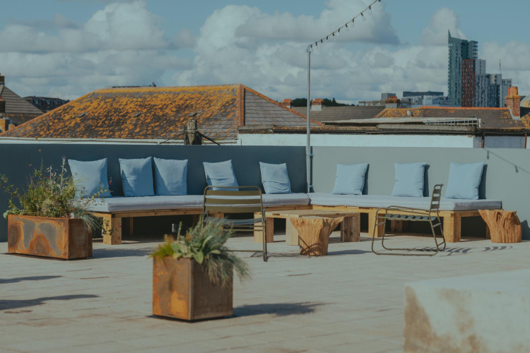 Rooftop terrace at Light Studios Plymouth featuring built-in seating, city views and outdoor planters in a creative workspace setting