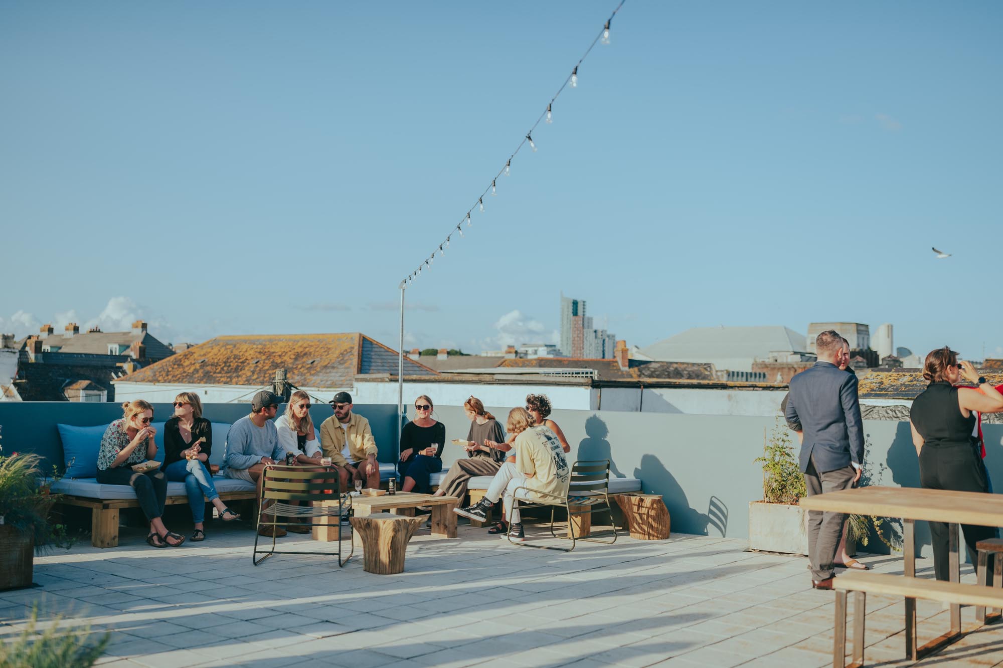 Rooftop at Light Studios in Plymouth with residents socialising under open skies and city views