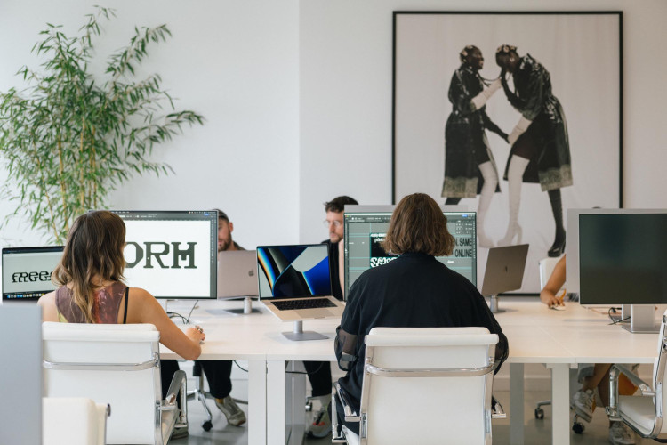 Designers working at large monitors in a Netil House studio filled with natural light, reflecting collaborative creative workspaces
