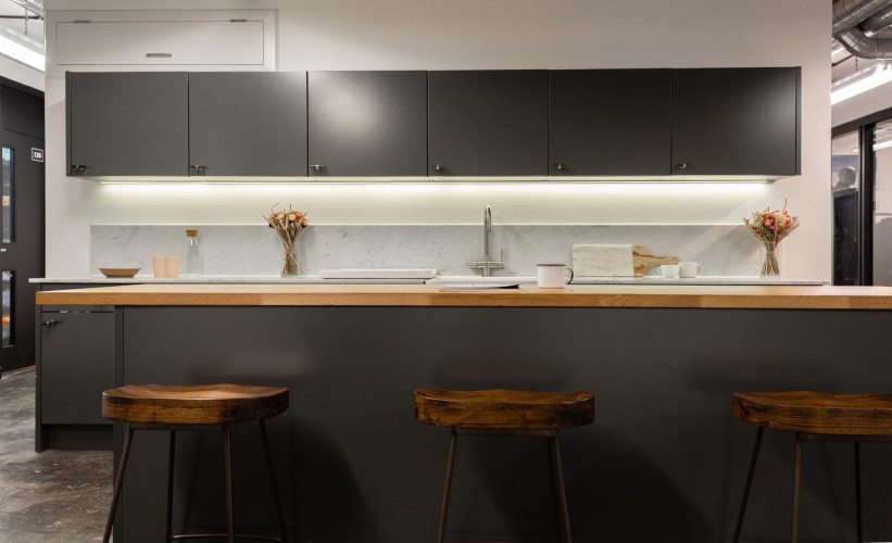 Contemporary communal kitchen at Netil House with natural wood finishes and a sleek monochrome palette