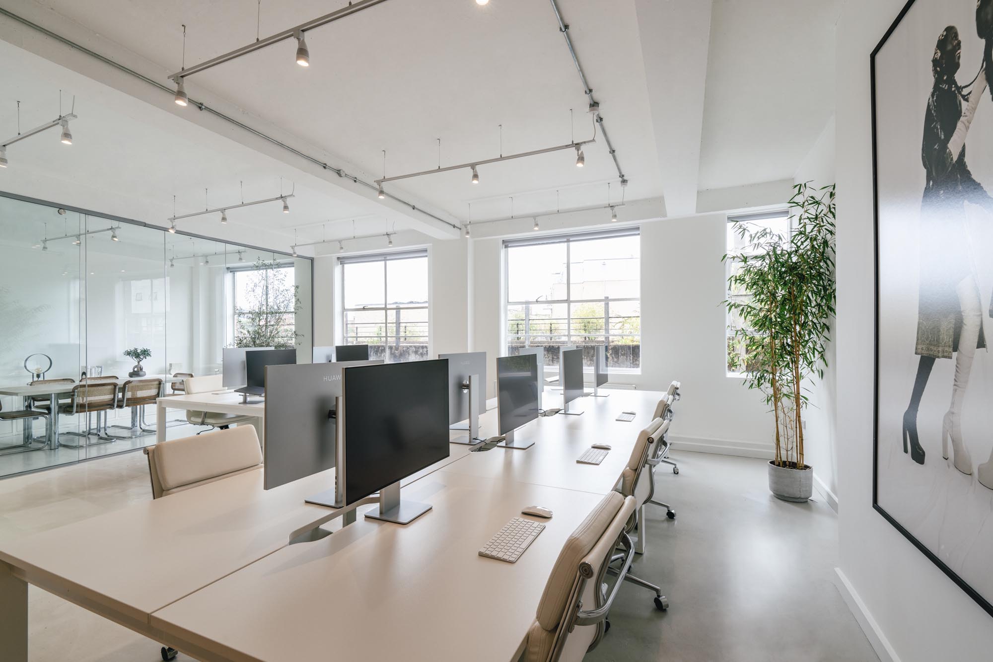 Spacious open-plan studio at Netil House with minimalist design, large windows and sleek workstations