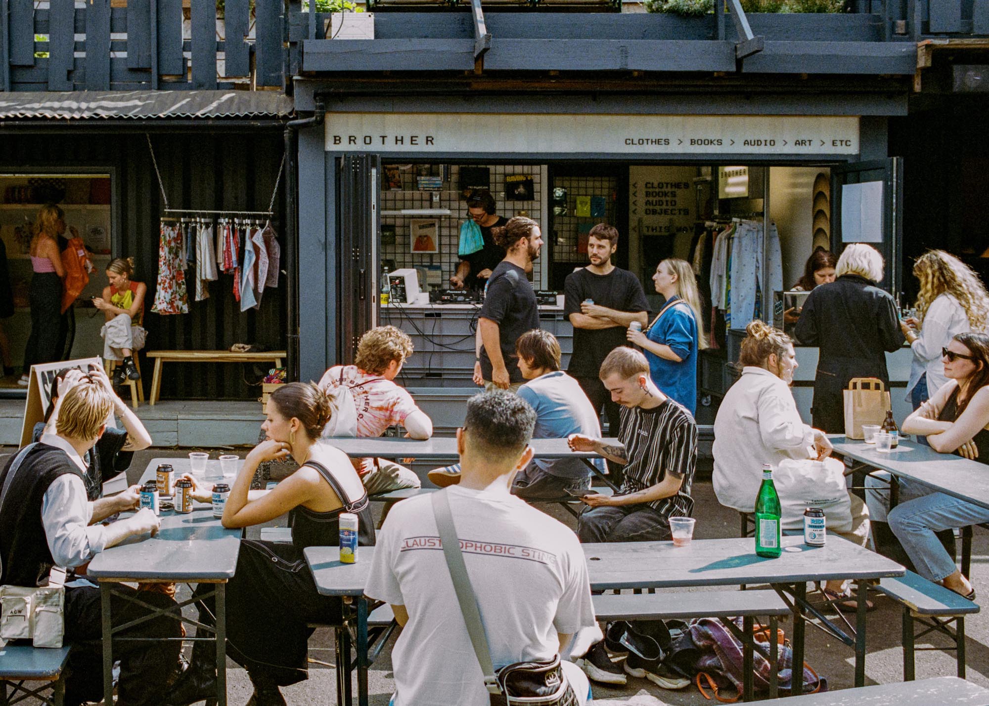 People enjoying food and drink outside Netil Market’s independent container shops in Hackney